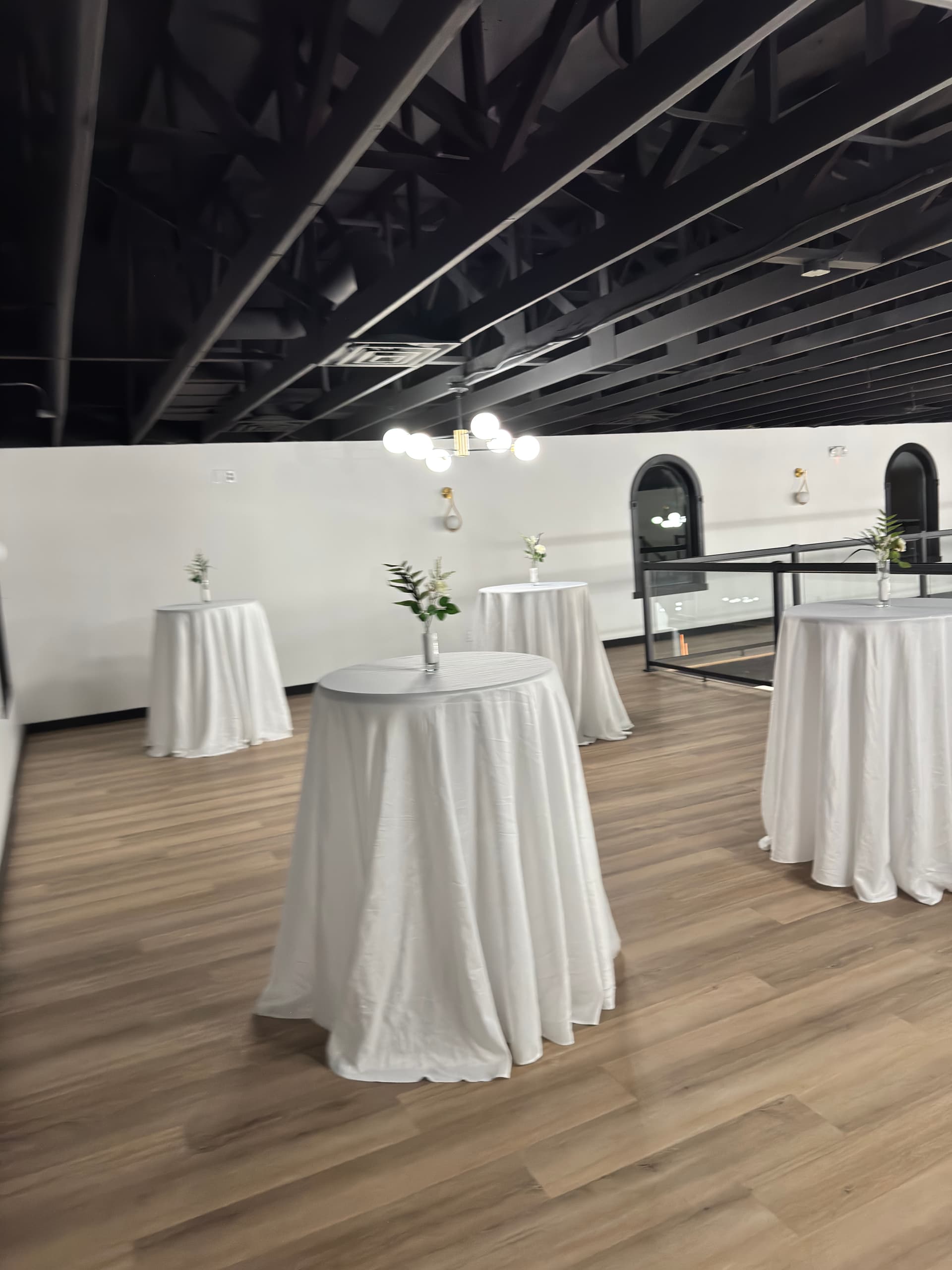 Cocktail tables on the mezzanine level at Altar'd Event Venue